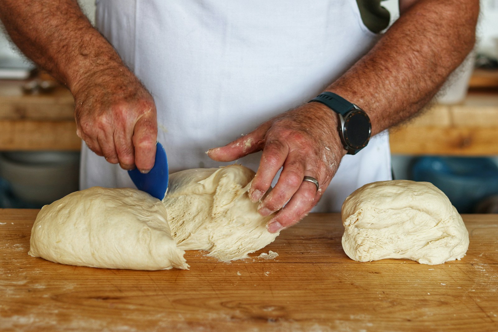 person in white shirt holding dough