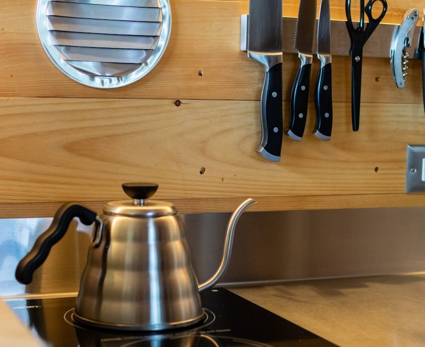 a stove top with a tea pot on top of it